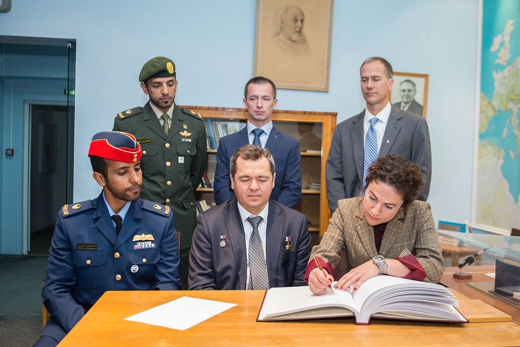 Expedition 61 crewmember Jessica Meir of NASA signs a commemorative book in the Gagarin Museum